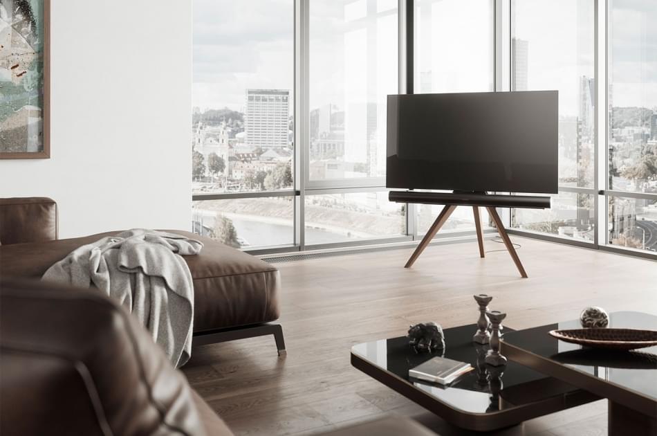 Spectral tv stand on living room full of windows with a great view over the city